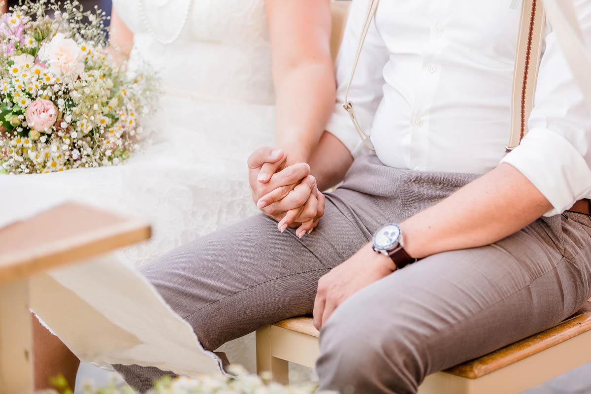 Hochzeit auf der Alm: Brautpaar vor dem Allgäuer Bergpanorama, Braut im kurzen Vintage-Spitzenkleid