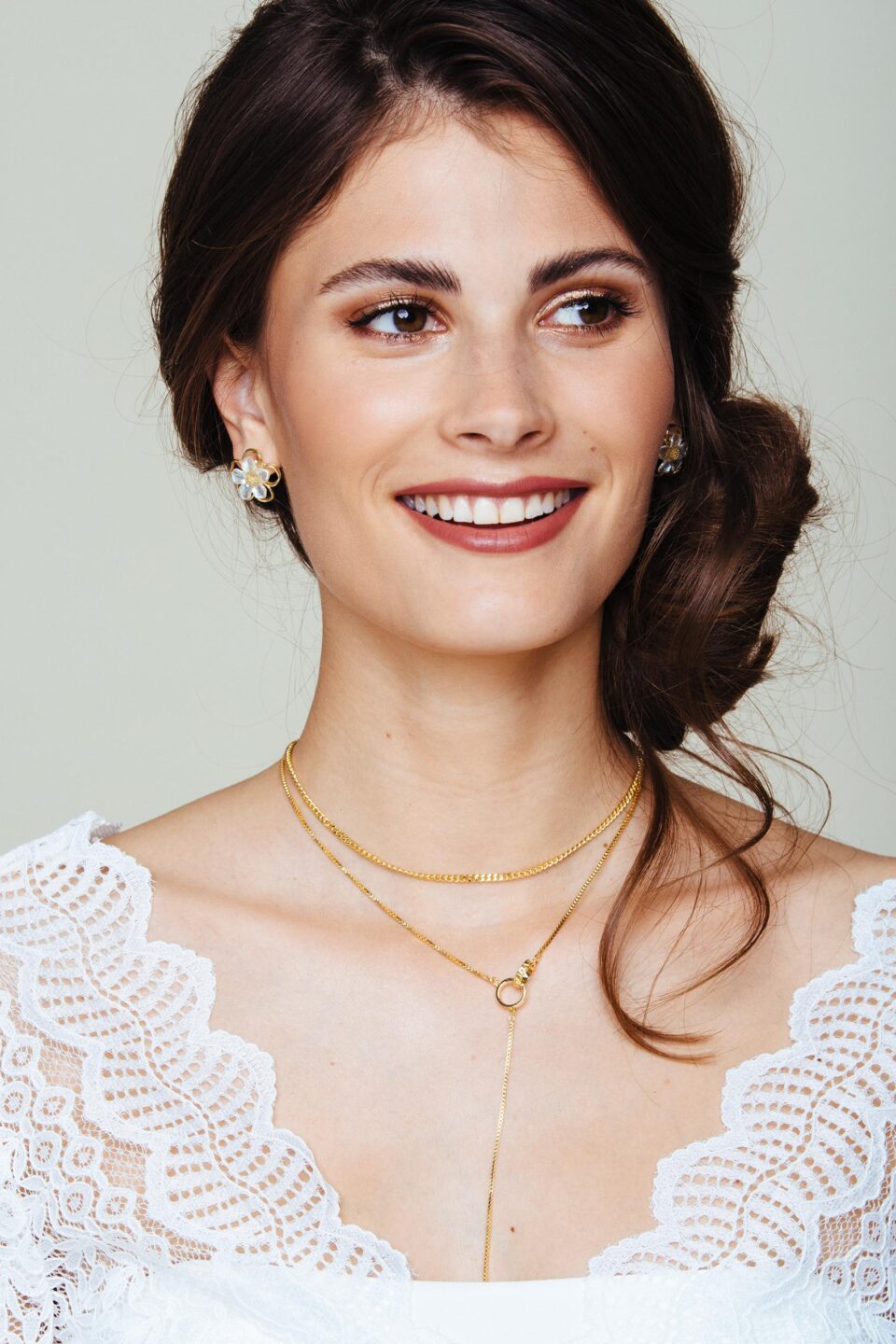 lächelnde Braut mit V-Ausschnitt und Goldkette
